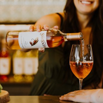 Sawtooth Winery - a woman pouring a glass of wine - Wineries Near Me - Caldwell, Idaho