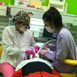 Yu Jocelyn E, DDS - Dr. Yu working on a young adolescent