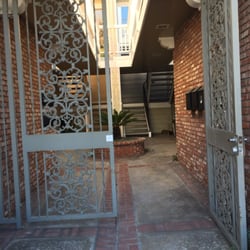 Hey Sugar - It's like a hidden door. You have to walk through these gates and it's gonna be on your right. Front door is black with curtains