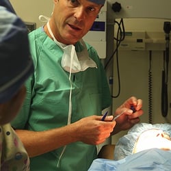 Aesthetic Surgery Center:  Michael R. Macdonald, MD - Dr. Mac instructs OR staff as he preps for surgery. He's an expert surgeon with 19 years in practice plus teaching for UCSF.