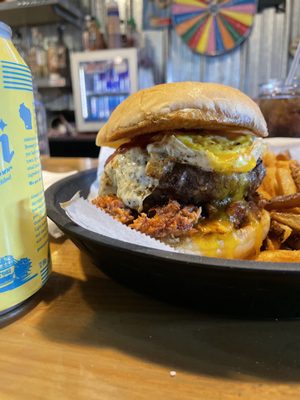 Photo of The Garage - Kenosha, WI, US. Beef Burger stuffed with cheese curds and pepper jack cheese, topped with barbecue pulled pork and a fried egg!!