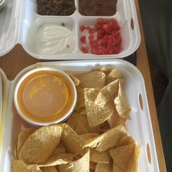 Taco Casa - Super Nachos toppings on the side and tons of liquid gold in a cup