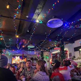 Miracle - a group of people sitting at a table in a restaurant - Bars Near Me - Denver, Colorado Miracle - a group of people sitting at a table in a restaurant - Bars Near Me - Denver, Colorado