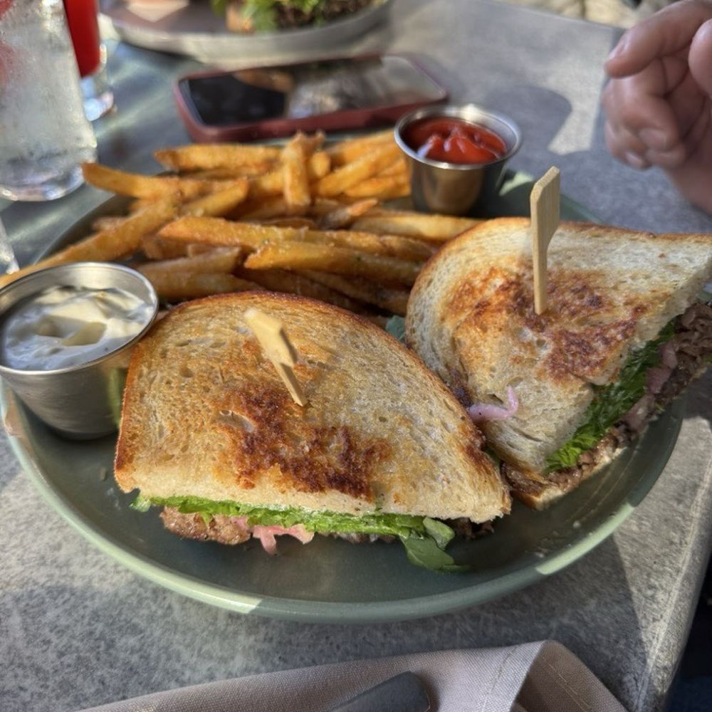 Creekhouse Kitchen & Bar - Brisket Sandwich with a side of fries and aioli - New American Near Me - Wimberley, Texas Creekhouse Kitchen & Bar - Brisket Sandwich with a side of fries and aioli - New American Near Me - Wimberley, Texas