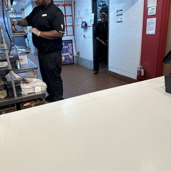 KFC - Young man who finally prepared my order after my 15+ minute wait and passing the buck on who was supposed to prepare it. - Fast Food Near Me - Baltimore, Maryland