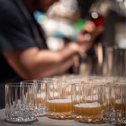 J Guerrero Photography - Beverage director portioning cocktails for an event