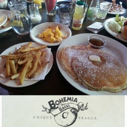 Fluffly pancakes, scrambled eggs with cheese, and french fries all washed down with apple juice Fluffly pancakes, scrambled eggs with cheese, and french fries all washed down with apple juice