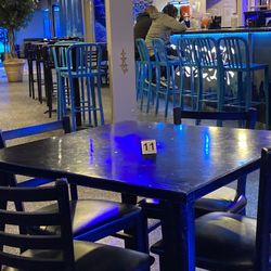 Godfreys - Seating for restaurant with bar in background..