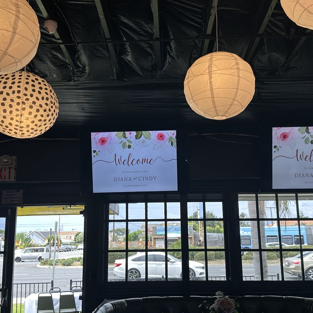 XO Event Space - tv screens surrounding the venue with a peak of the patio area with table and chairs set up outside - Venues & Event Spaces Near Me - Westminster, California XO Event Space - tv screens surrounding the venue with a peak of the patio area with table and chairs set up outside - Venues & Event Spaces Near Me - Westminster, California