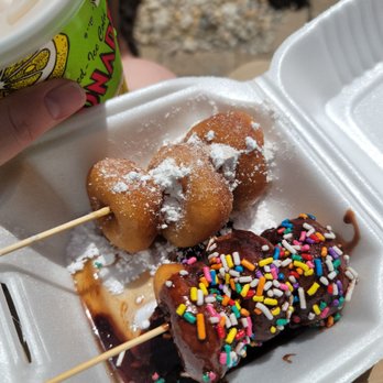 Meaney's Mini Donuts - a person holding a cup of coffee - Donuts Near Me - Sarasota, Florida Meaney's Mini Donuts - a person holding a cup of coffee - Donuts Near Me - Sarasota, Florida