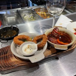 La Tortilla - Two tapas - calamari and chorizo Don't forget to ask for a slice or two of sourdough to soak up that sauce...