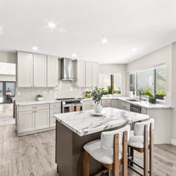 Huntington & Ellis - Updated kitchen featuring a large island, stainless steel appliances, modern cabinetry, and plenty of counter space.