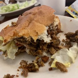 Pepper steak sub served with lays chips.