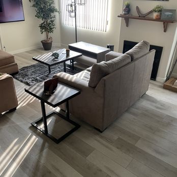 Sviri Construction - a living room with couches and a fireplace - General Contractors Near Me