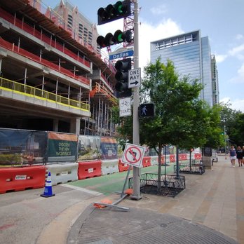 Discovery Green - A building, construction spilled over the street and bike only lanes. - Parks Near Me - Houston, Texas