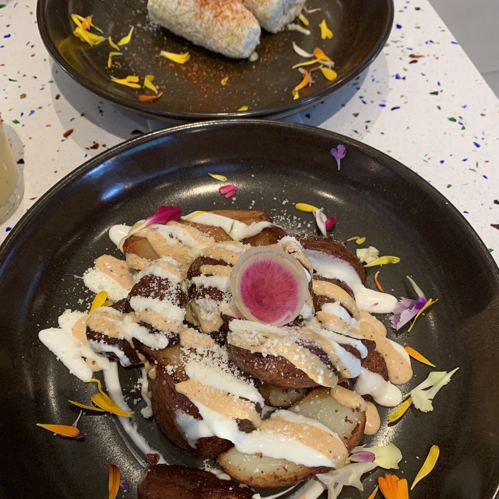 Urbe - Far back is the ELOTE ASADO (street corn) and forward is the PAPAS BRAVAS - Mexican Near Me - Houston, Texas Urbe - Far back is the ELOTE ASADO (street corn) and forward is the PAPAS BRAVAS - Mexican Near Me - Houston, Texas
