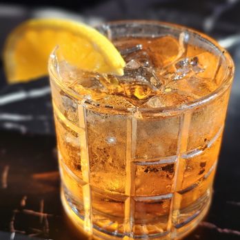 Novo Italian - a close up of a drink with ice and a slice of lemon - Wine Bars Near Me - Vancouver, British Columbia Novo Italian - a close up of a drink with ice and a slice of lemon - Wine Bars Near Me - Vancouver, British Columbia