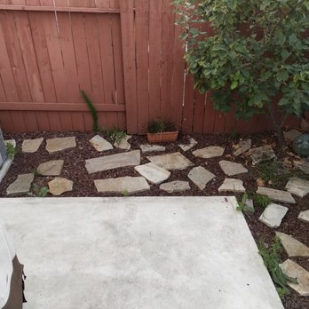 Sand and Soleil Landscape - Before by the tree, with the excessive concrete. - Landscaping Near Me