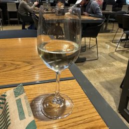 a glass of wine on a table a glass of wine on a table