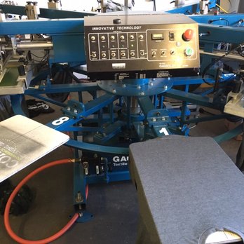 Spent Graphics - One of there machines to print on t-shirts. - Screen Printing/T-Shirt Printing Near Me - Huntington Beach, California Spent Graphics - One of there machines to print on t-shirts. - Screen Printing/T-Shirt Printing Near Me - Huntington Beach, California