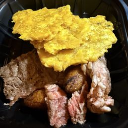 New York steak and tostones. New York steak and tostones.