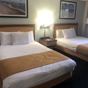 Dunes Waterfront Resort - Two-queen portion of the basement two-room suite. - Hotels Near Me - Mears, Michigan