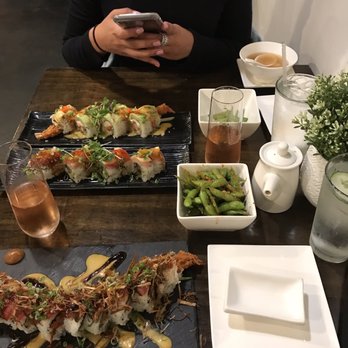 M Sushi Bistro - Spicy garlic edamame, all in one roll, Snow White roll, (don't know the roll in the middle), and peach mango champagne - Sushi Bars Near Me - Lodi, California