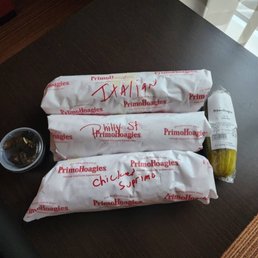 An Italian Fully Loaded, Philly Cheese Steak, & Chicken Parmigiana Supremo Hoagies W/Pickle and hot peppers.