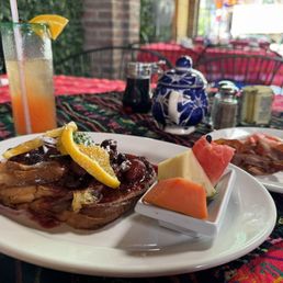 Berries French toast with side of bacon and tequila sunrise