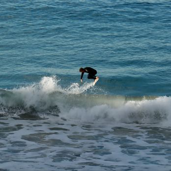 Dana Strand Beach - Surfer performing a trick - Beaches Near Me - Dana Point, California
