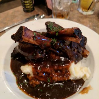 Rosine's Restaurant - Braised Lamb Shanks in a rich Demi-glace over homemade mashed potatoes. - American Near Me - Monterey, California Rosine's Restaurant - Braised Lamb Shanks in a rich Demi-glace over homemade mashed potatoes. - American Near Me - Monterey, California