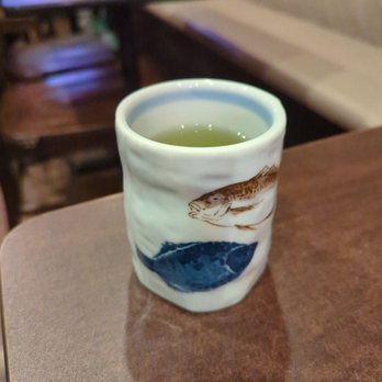Kitani Sushi - a cup of green tea on a table - Sushi Bars Near Me - Cumming, Georgia