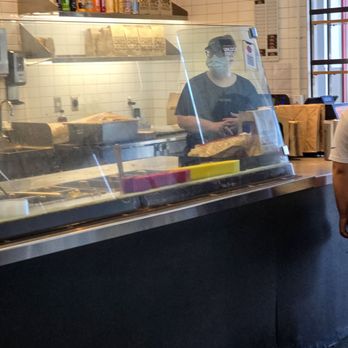 Chipotle Mexican Grill - The cashier wearing a face mask awaits behind the cashier counter to charge the customer for his order - Mexican Near Me - Roanoke, Virginia Chipotle Mexican Grill - The cashier wearing a face mask awaits behind the cashier counter to charge the customer for his order - Mexican Near Me - Roanoke, Virginia