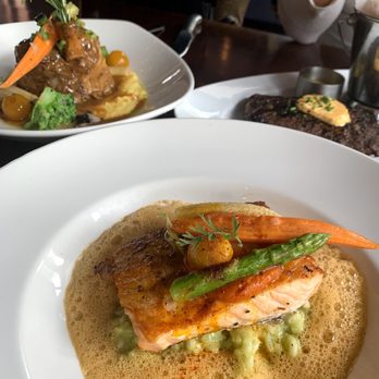 Maison Pucha Bistro - pork "osso bucco", salmon with risotto, and steak frites - French Near Me - Houston, Texas