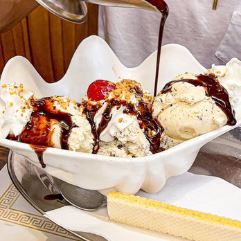 Margie's Candies - a man pouring syrup over a bowl of ice cream - Candy Stores Near Me - Chicago, Illinois Margie's Candies - a man pouring syrup over a bowl of ice cream - Candy Stores Near Me - Chicago, Illinois