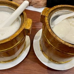Mango/coconut with sago (left) and sweet bean curd (tofu) with red bean served in wooden mini buckets