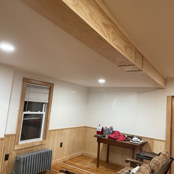DLJ Quality Contracting - a living room with wood paneling - General Contractors Near Me DLJ Quality Contracting - a living room with wood paneling - General Contractors Near Me