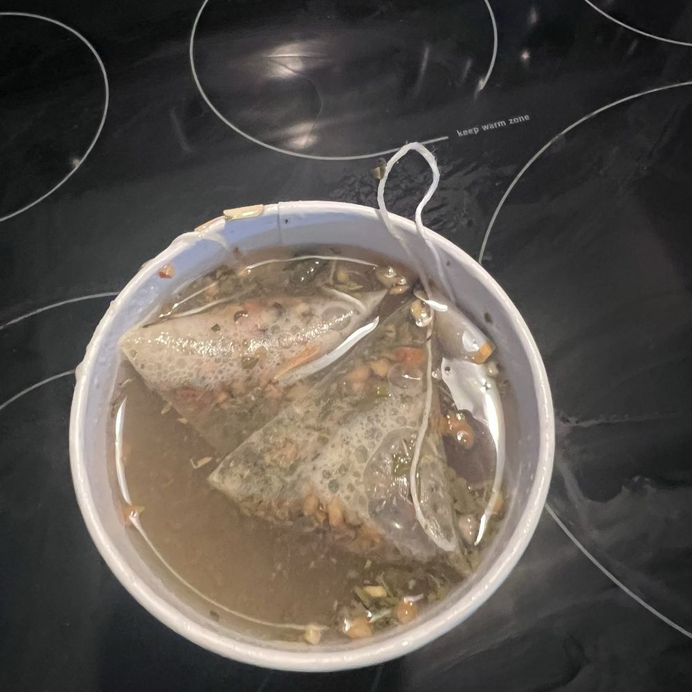 Honey Citrus Mint Tea with loose tea floating Honey Citrus Mint Tea with loose tea floating