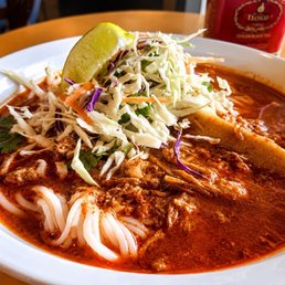 Khao Soi--rich coconut curry broth, tender braised meat, silky noodles, and fresh cabbage with a squeeze of lime. Comfort in a bowl.