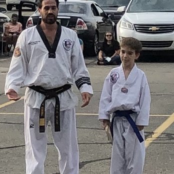 Olympia Taekwondo - Senior Master Alex with our son at a testing. - Taekwondo Near Me - Canton, Michigan Olympia Taekwondo - Senior Master Alex with our son at a testing. - Taekwondo Near Me - Canton, Michigan