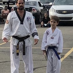 Olympia Taekwondo - Senior Master Alex with our son at a testing.