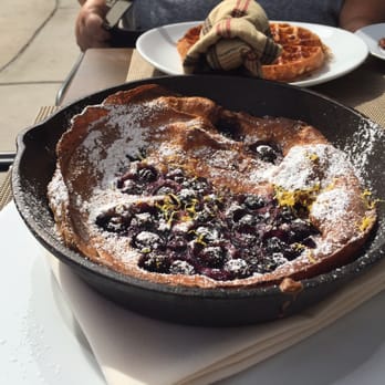 The Osprey - Dutch baby at brunch with waffles in the background - Seafood Near Me - Orlando, Florida