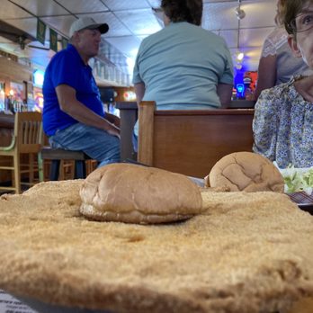 Smitty's Bar & Grill - a woman sitting at a table with a large plate of food - Bars Near Me - Leonore, Illinois