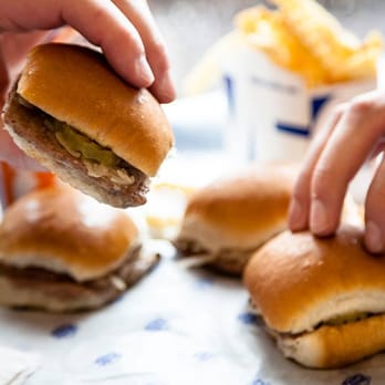 White Castle - a person taking a bite out of a hamburger - Fast Food Near Me - Pontiac, Michigan White Castle - a person taking a bite out of a hamburger - Fast Food Near Me - Pontiac, Michigan