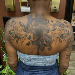 Anna Waychoff did this floral black and gray back tattoo