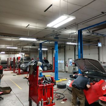 Ken's Pit Stop - Inside look at the 4 bays and accompanying lifts in the Automotive and Tire Center. Also, one of our technicians working on a repair! - Auto Repair Near Me - Rifle, Colorado Ken's Pit Stop - Inside look at the 4 bays and accompanying lifts in the Automotive and Tire Center. Also, one of our technicians working on a repair! - Auto Repair Near Me - Rifle, Colorado
