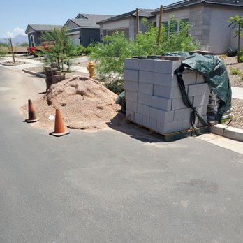 Lobos Landscaping - The material they dropped months ago in front of our house. It's rained multiple times since so the concrete bags unusable now. - Landscaping Near Me