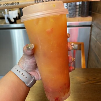 Royaltea - a person holding a plastic cup with a wooden spoon sticking out of it - Bubble Tea Near Me - Calgary, Alberta