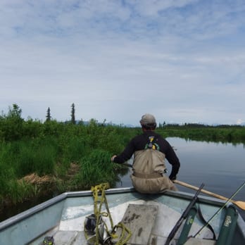 Lake Marie Lodge - Our guide quietly rowing us to a new spot on the river - Fishing Near Me Lake Marie Lodge - Our guide quietly rowing us to a new spot on the river - Fishing Near Me