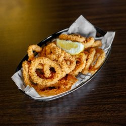 Crispy fried calamari served with fresh lemon. A crunchy seafood appetizer perfect for sharing.